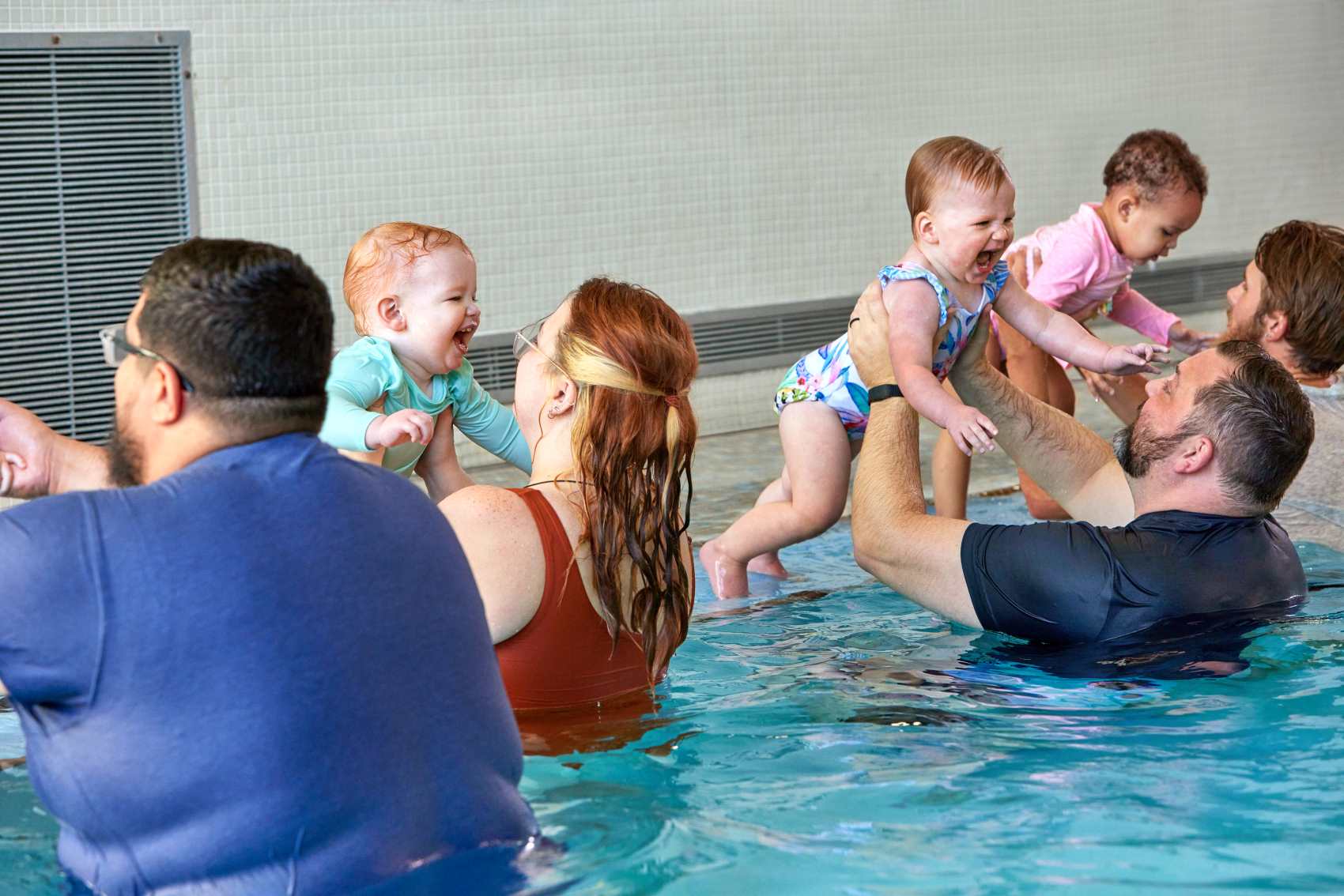 infants with parents in swim lessons