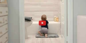 A baby is about to pull up on the side of a bathtub. youtube video 